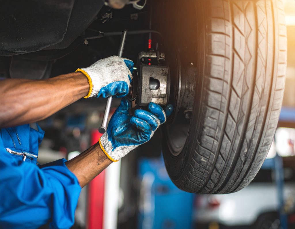 Firefly_Hyper-realistic close-up of an African male technician in clean blue overalls repairi 773905 - Carbon Car Care – Driving Africa’s automotive market Suspension Repair in Malawi
